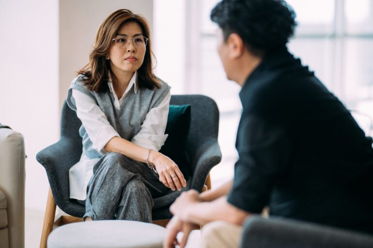 Asian female caregiver providing respite care in a home setting